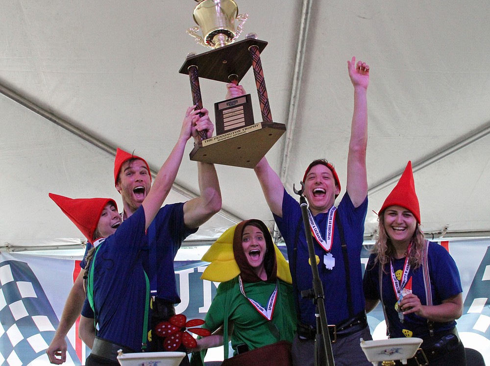 The Austin Weirdos accept their trophy after winning their division of the Running of the Tubs in June 2019. - File photo by The Sentinel-Record