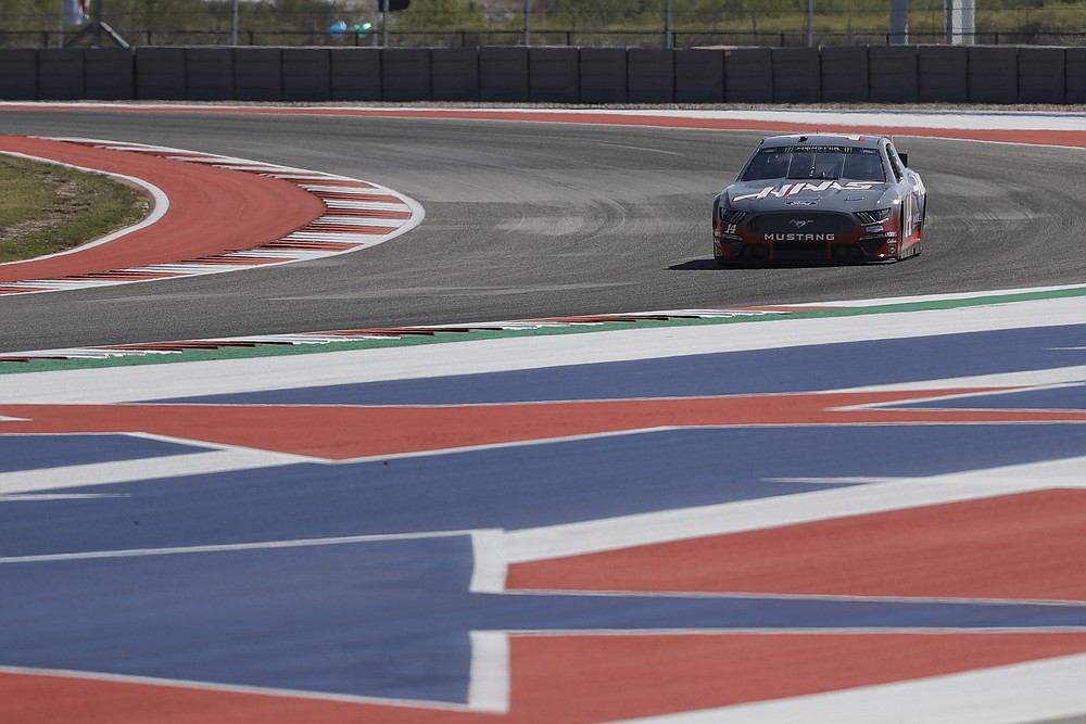 FILE - In this Oct. 31, 2019, file photo, Haas Formula 1 drivers Romain Grosjean, of France, and Kevin Magnussen, of Denmark, drive a NASCAR Cup Series car owned by Stewart-Haas Racing at the Formula One U.S. Grand Prix auto race at the Circuit of the Americas in Austin, Texas. After several years of competing on the racing calendar with F1's annual stop in Austin, NASCAR brings stock car racing to a new road course where the drivers say they're excited to bump their way through the turns and s-curves carved out of rolling scrub land of Central Texas. (AP Photo/Darron Cummings, File)