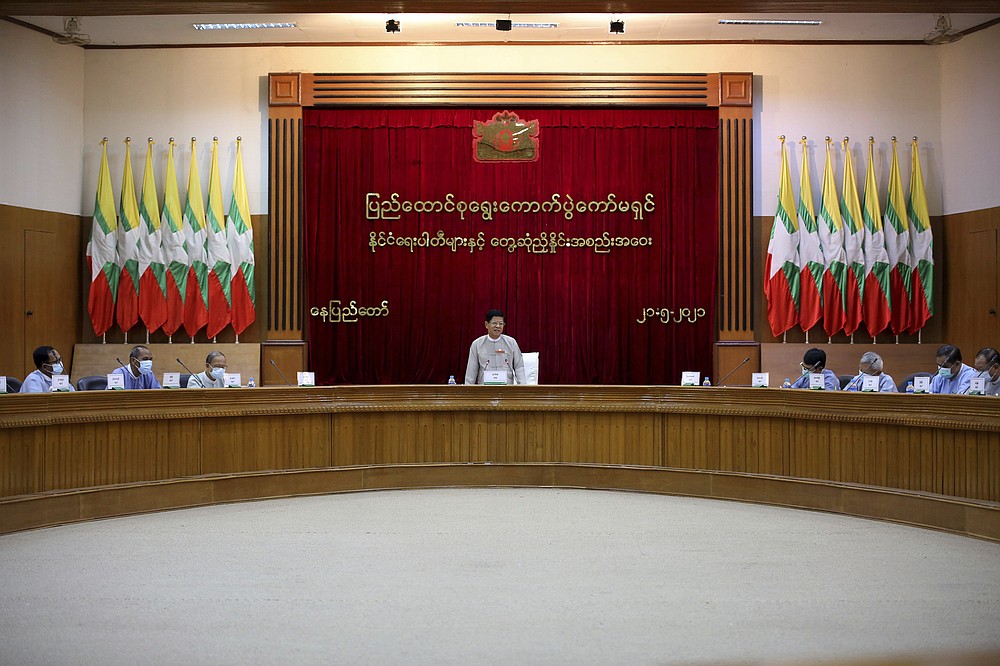 Union Election Commission Chairman Thein Soe, center, speaks during a meeting with representatives of various political parties Friday, May 21, 2021 in Naypyitaw, Burma. The head of Burma's military-appointed state election commission said Friday his agency will consider dissolving the former ruling party of Aung San Suu Kyi for its alleged involvement in electoral fraud, and have its leaders charged with treason. (AP Photo)