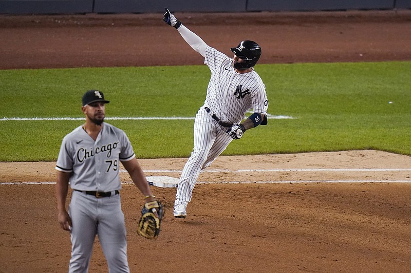 New York Yankees' Gleyber Torres runs the bases after hitting a home run, near Chicago White Sox first baseman Jose Abreu during the seventh inning of a baseball game Friday, May 21, 2021, in New York. (AP Photo/Frank Franklin II)