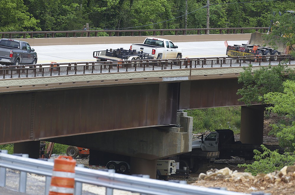Vehicles cross the span Thursday that’s replacing the old Pruitt bridge. The new bridge, which opened May 14, is 327 feet longer than the old span and 45 feet wide, compared with the old span’s 20-foot width.
(NWA Democrat-Gazette/Charlie Kaijo)