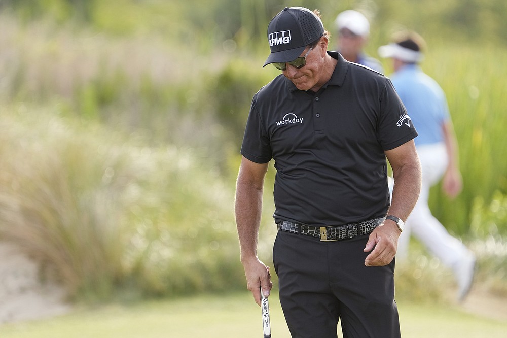 Phil Mickelson reacts after his double boggie shot on the 13th hole during the third round at the PGA Championship golf tournament on the Ocean Course, Saturday, May 22, 2021, in Kiawah Island, S.C. (AP Photo/David J. Phillip)