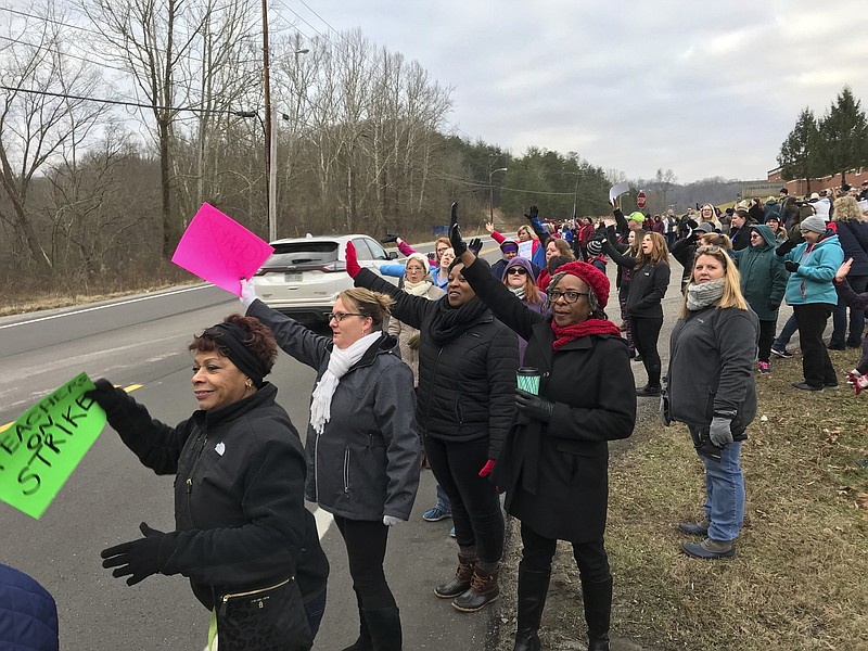 FILE - In this Feb. 19, 2019, file photo, West Virginia teachers gathered at Capital High School in Charleston, W Va., morning to protest the Omnibus Bill that is moving through the Legislature. West Virginia has seen a higher percentage of residents depart than any other state in the past decade. Teachers are leaving for better-paying jobs, especially in bordering states. (Kenny Kemp/The Daily Mail via AP)