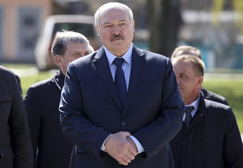 FILE - In this Monday April 26, 2021 file photo, Belarus President Alexander Lukashenko, accompanied by officials, attends a requiem rally on the occasion of the 35th anniversary of the Chernobyl disaster in the town of Bragin, some 360 km (225 miles) south-east of Minsk, Belarus. Raman Pratasevich, a founder of a messaging app channel that has been a key information conduit for opponents of Belarus’ authoritarian president, has been arrested after an airliner in which he was riding was diverted to Belarus because of a bomb threat. The presidential press service said President Alexander Lukashenko personally ordered that a MiG-29 fighter jet accompany the Ryanair plane — traveling from Athens, Greece, to Vilnius, Lithuania — to the Minsk airport. (Sergei Sheleg/BelTA Pool Photo via AP, File)