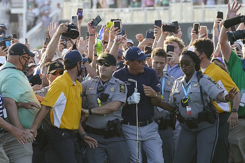 Phil Mickelson wades through fans on the 18th fairway during the final round at the PGA Championship golf tournament on the Ocean Course, Sunday, May 23, 2021, in Kiawah Island, S.C. (AP Photo/Matt York)