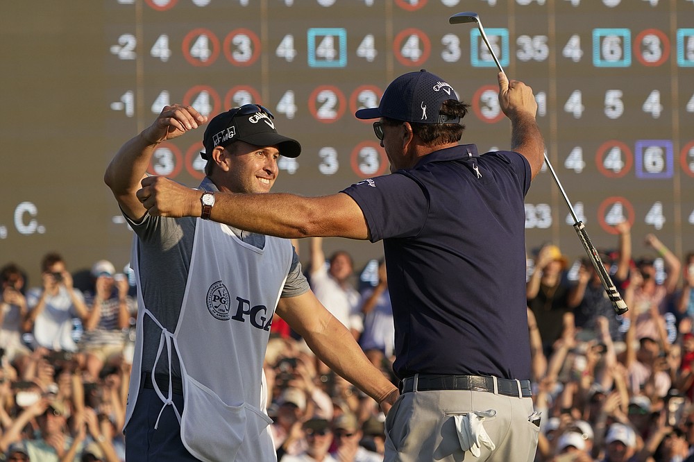 Phil Mickelson hugs his brother and caddie Tim after winning the final round at the PGA Championship golf tournament on the Ocean Course, Sunday, May 23, 2021, in Kiawah Island, S.C. (AP Photo/Chris Carlson)