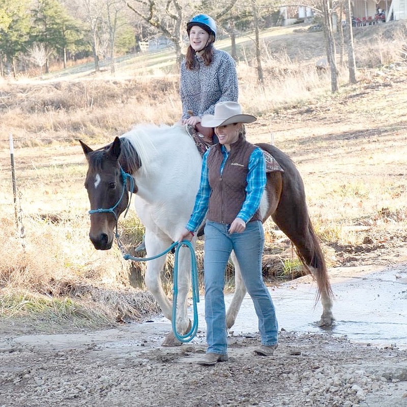 COURTESY PHOTO Summer Myers of Twin Willows Stables in Jacket leads a girl on a pony ride. The business also offers trail rides for beginners to experienced riders and riding lessons.