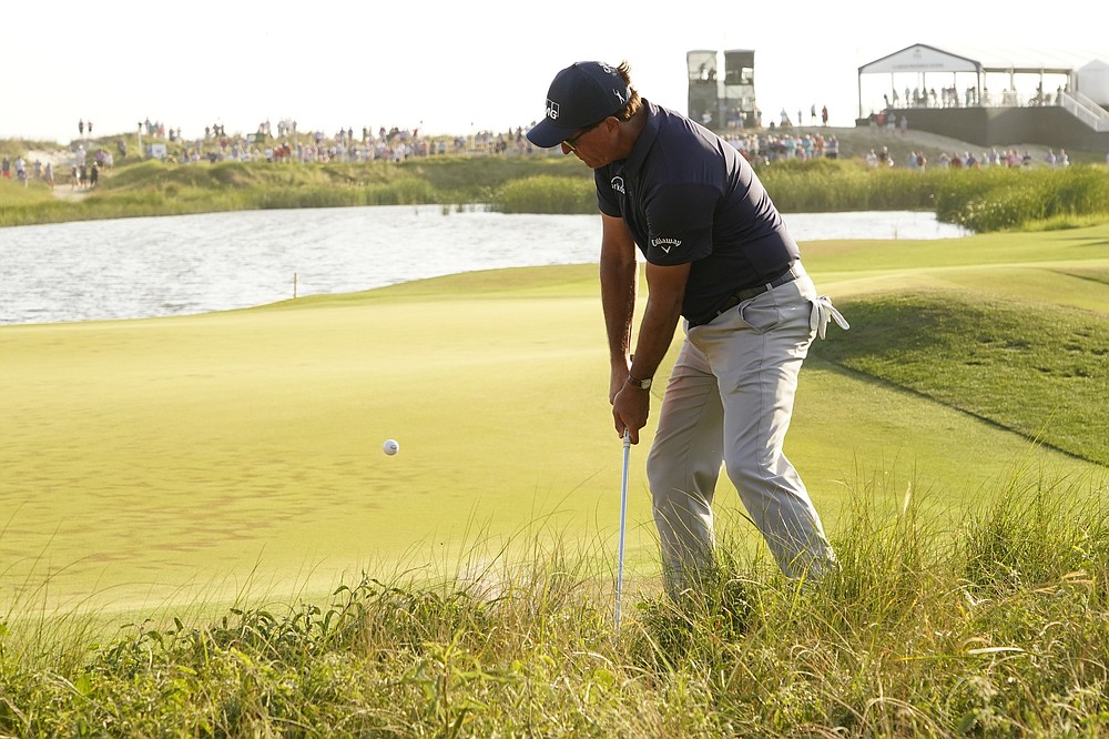 Phil Mickelson hits out of the rough the 17th hole during the final round at the PGA Championship golf tournament on the Ocean Course, Sunday, May 23, 2021, in Kiawah Island, S.C. (AP Photo/Matt York)