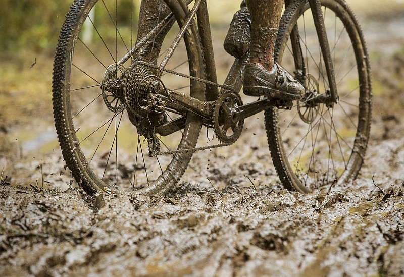 A competitor in the UCI Junior Men race pedals through mud Sunday, Oct. 6, 2019, during the the Fayettecross cyclocross races at Centennial Park at Millsap Mountain in Fayetteville. (NWA Democrat-Gazette/NWA Democrat-Gazette File Photo/BEN GOFF )