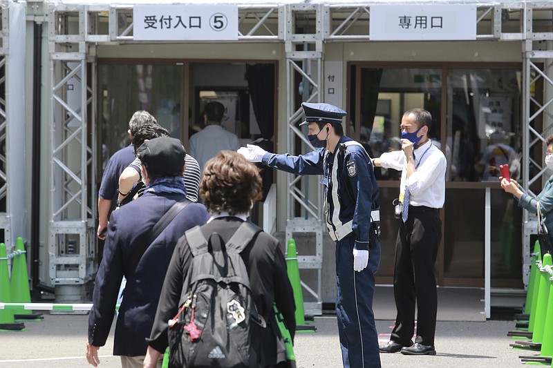 People enter the newly-opened mass vaccination center to receive the Moderna coronavirus vaccine in Tokyo, Monday, May 24, 2021. Japan mobilized military doctors and nurses to give shots to elderly people in Tokyo and Osaka on Monday as the government desperately tries to accelerate its vaccination rollout and curb coronavirus infections just two months before hosting the Olympics. (AP Photo/Koji Sasahara)