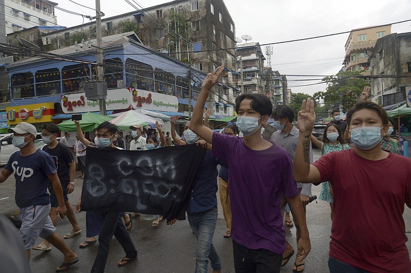 Anti-coup protesters flash the three-finger salute during a demonstration against the military takeover, in Yangon, Myanmar, Monday, May 24, 2021. (AP Photo)