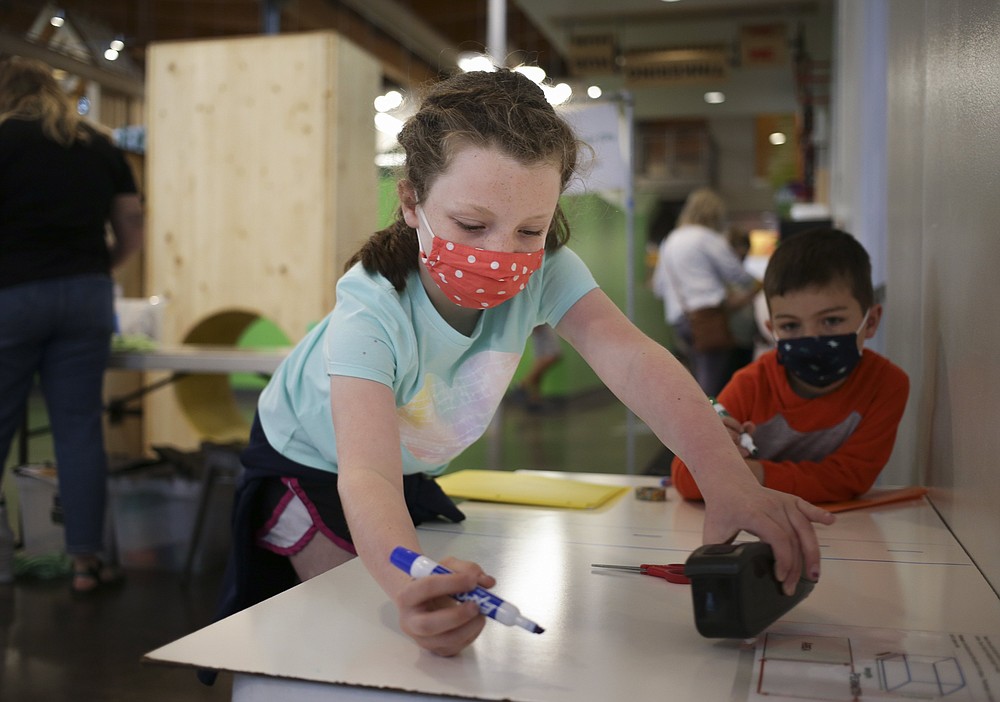 Campbell Couch (left) and Elliott Couch, 4, both of Grapevine, Texas, make their own city design using crafting tools at the Amazeum in Bentonville. Summer campers can learn about being an architect — or a marine biologist or astronaut or game developer — at the Bentonville children's museum.
(NWA Democrat-Gazette File Photo/Charlie Kaijo)