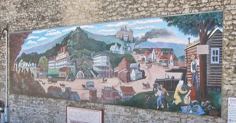 A downtown mural sums up Eureka Springs history since the city’s 1879 founding. (Special to the Democrat-Gazette/Marcia Schnedler)