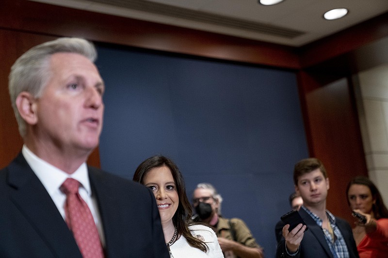 Newly-elected House Republican Conference Chair Rep. Elise Stefanik, R-N.Y., second from left, watches as House Minority Leader Kevin McCarthy of Calif., left, speaks to reporters at the Capitol in Washington, Friday, May 14, 2021. (AP Photo/Andrew Harnik)