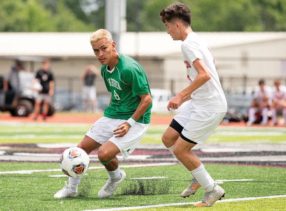Pedro Rodriguez (left) looks to pass the ball during the Class 5A boys soccer championship in Benton. Rodriguez is the All-NWADG Boys Soccer Player of the Year after leading Van Buren to the 5A state championship.
(Arkansas Democrat-Gazette/Justin Cunningham)