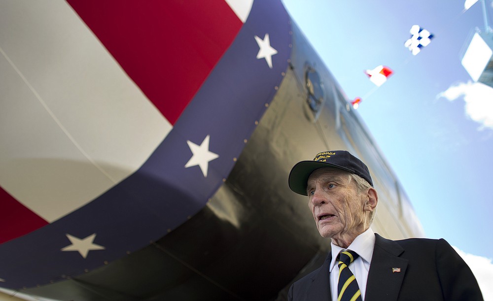 FILE - In this Sept. 6, 2014 file photo former Sen. John Warner of Virginia tours the new submarine that bears his name hours before the formal christening at Newport News Shipbuilding, in Newport News, Va. Warner, a former Navy secretary who was once married to Elizabeth Taylor, died Tuesday, May 25, 2021, at 94, his longtime chief of staff said Wednesday, May 26. (L. Todd Spencer/The Virginian-Pilot via AP, File)