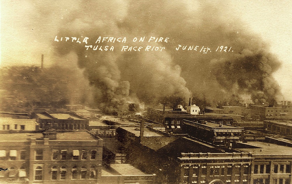 This postcard provided by the Department of Special Collections, McFarlin Library, The University of Tulsa shows fires burning during the Tulsa Race Massacre in Tulsa, Okla. on June 1, 1921. (Department of Special Collections, McFarlin Library, The University of Tulsa via AP)
