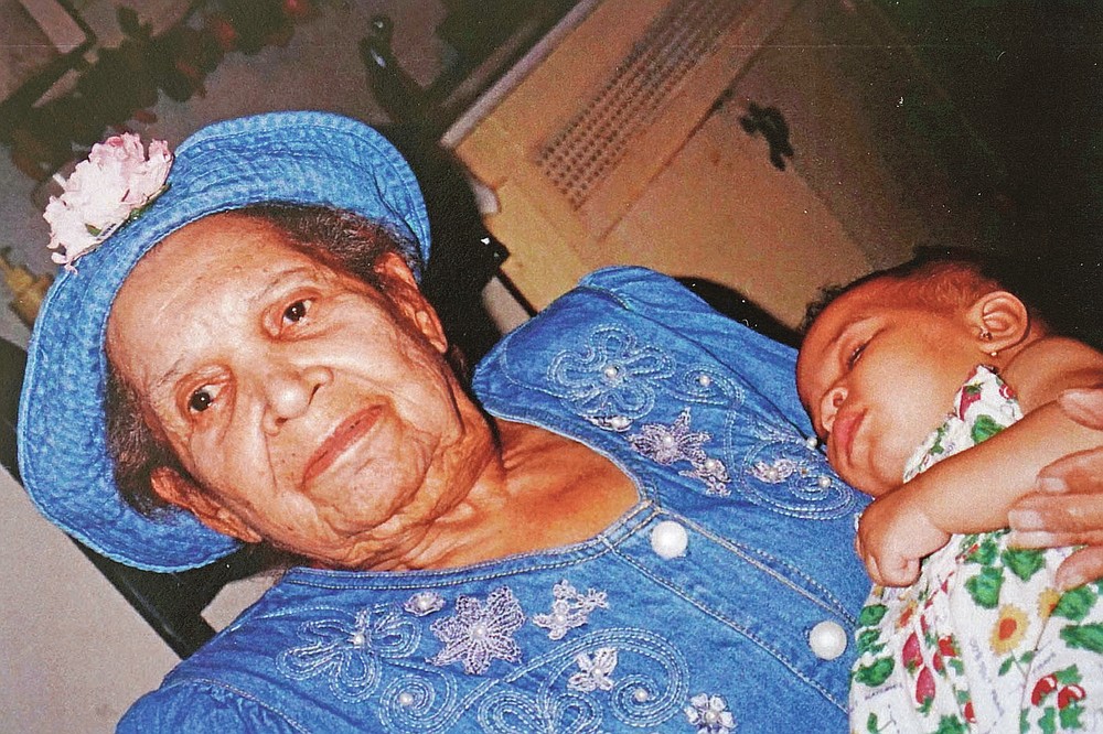 In this undated photo provided by Carolyn Roberts of the Gibbs family in April 2021, Tulsa Race Massacre survivor Ernestine Alpha Gibbs holds one of her grandchildren, DeShayla Roberts, two decades earlier. (Courtesy Carolyn Roberts via AP)