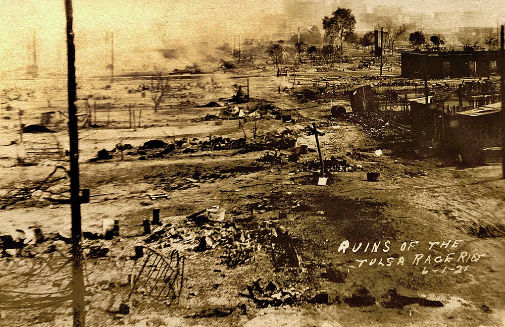 This photo provided by the Department of Special Collections, McFarlin Library, The University of Tulsa shows the ruins of Dunbar Elementary School and the Masonic Hall in the aftermath of the June 1, 1921, Tulsa Race Massacre in Tulsa, Okla. (Department of Special Collections, McFarlin Library, The University of Tulsa via AP)
