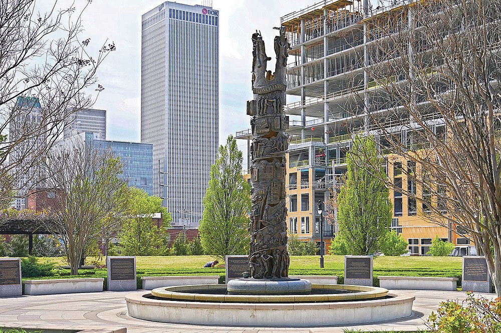 A sculpture commemorating the Tulsa Race Massacre stands in John Hope Franklin Reconciliation Park in Tulsa, Okla., on Wednesday, April 14, 2021, with new construction in the background. (AP Photo/Sue Ogrocki)