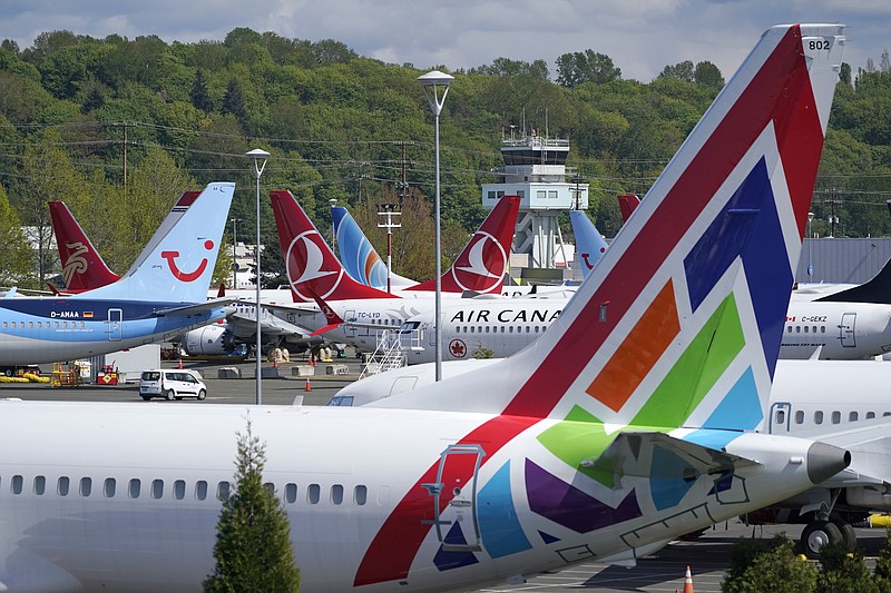 Boeing 737 Max airplanes sit parked in a storage lot, Monday, April 26, 2021, near Boeing Field in Seattle.  Boeing is paying $17 million and promising to take steps to fix production problems with its popular 737 jets. The Federal Aviation Administration said Thursday, May 27,  that the settlement covers the installation of unapproved sensors and other parts on some Boeing 737 models including NGs and the Max.   (AP Photo/Ted S. Warren)