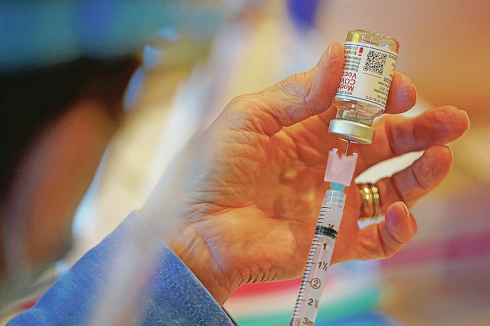FILE - In this Dec. 29, 2020, file photo, Pat Moore, with the Chester County, Pa., Health Department, fills a syringe with a Moderna COVID-19 vaccine before administering it to emergency medical workers and health care personnel at the Chester County Government Services Center in West Chester, Pa. On Friday, May 28, 2021, The Associated Press reported on stories circulating online incorrectly asserting that the variants of the coronavirus that have been found in the global population were created by COVID-19 vaccines. (AP Photo/Matt Slocum, File)