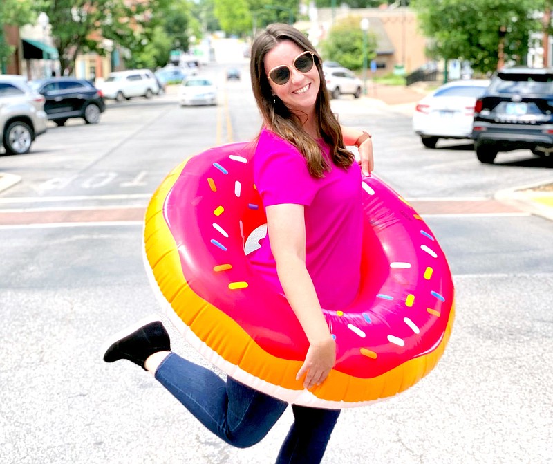 Photo submitted. Abby Trinidad of Main Street Siloam Springs models an inflatable doughnut which part of the prize package of one of the giveaways for the second Girls Night Out of the year.