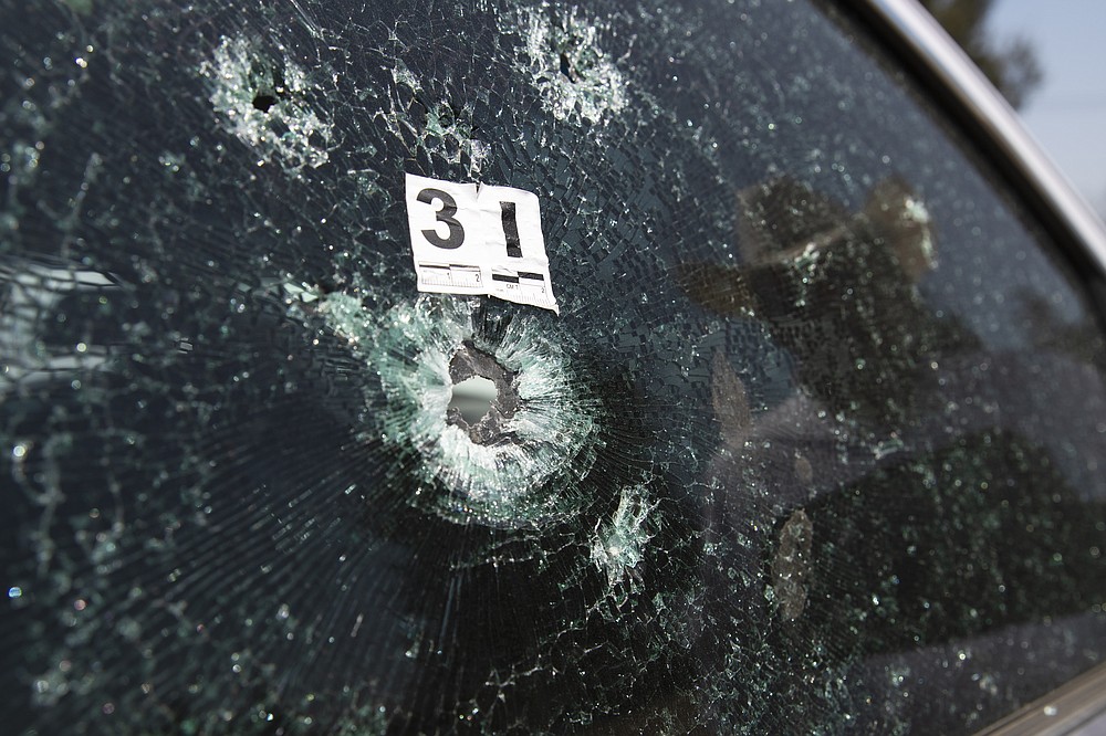 The windshield of mayoral candidate Guillermo Valencia is shattered after an attack in Morelia, Michoacan state, Mexico, Saturday, May 22, 202. The PRI candidate was not in the car and two members of his team survived the May 8 attack when a car pulled up and two young gunmen leaped out, one with an assault rifle and another with a pistol went around to finish off anybody trying to flee. (AP Photo/Marco Ugarte)