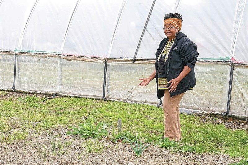 Billie Parker, owner of the Black Wall Street Market, walks through her garden area in Tulsa, Okla., on Saturday, April 10, 2021. The 6 miles between the old and new incarnations of Black Wall Street belie the dire connection that links them: Racial and socioeconomic inequality on Tulsa’s north side has its roots in the 100-year-old atrocity of the Tulsa Race Massacre. (AP Photo/Sue Ogrocki)