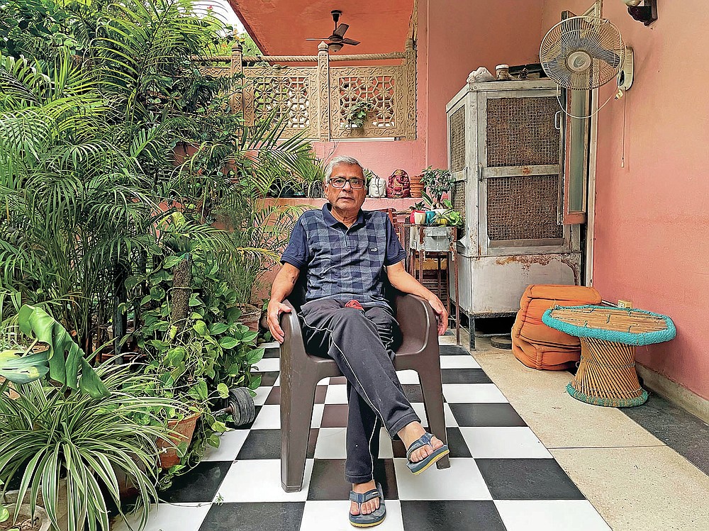 In this photo released by Chakravorty family, Prabir Chakravorty, 73, a COVID-19 survivor, sits in the garden area of his home in New Delhi, India on May 17, 2021. Chakravorty, the family patriarch and widower, a construction executive was treated at home for the coronavirus. (Chakravorty family via AP)