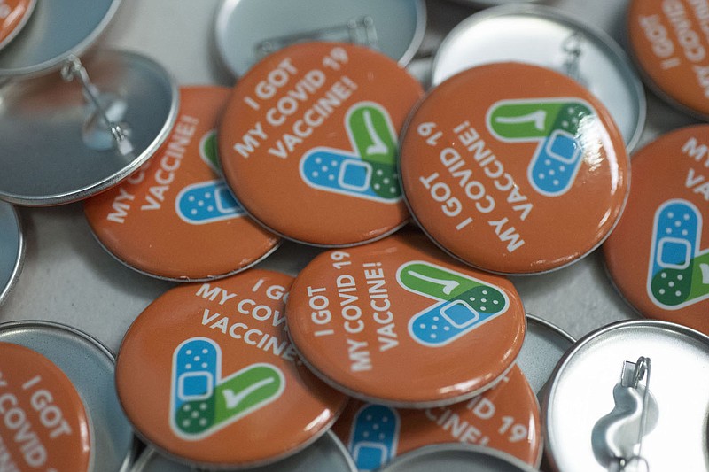 Buttons for people who receive the covid-19 vaccine on a table Wednesday May 26, 2021 at the Rogers Activity Center.Visit nwaonline.com/210530Daily/ and nwadg.com/photo. (NWA Democrat-Gazette/J.T. Wampler)