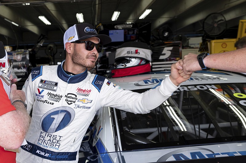 Kyle Larson fist bumps a member of his crew after qualifying in pole position for the NASCAR Cup Series auto race at Charlotte Motor Speedway on Saturday, May 29, 2021 in Charlotte, N.C. (AP Photo/Ben Gray)