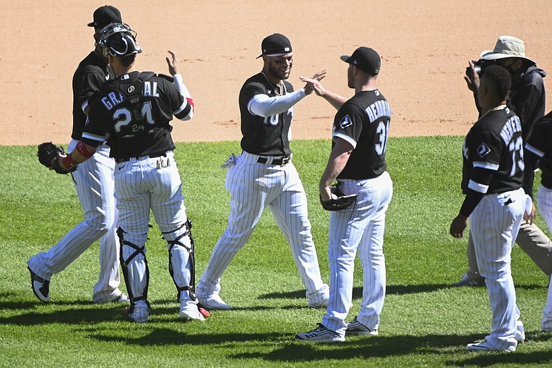 Chicago White Sox third baseman Yoan Moncada, third from left, celebrates with teammates at the end of the first baseball game of a doubleheader against the Baltimore Orioles, Saturday, May 29, 2021, in Chicago. (AP Photo/Matt Marton)
