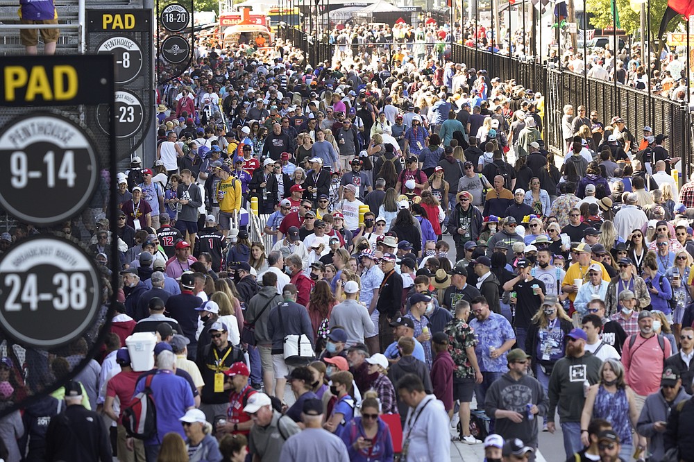 Fans enter the Indianapolis Motor Speedway before the Indianapolis 500 auto race in Indianapolis, Sunday, May 30, 2021. (AP Photo/Paul Sancya)