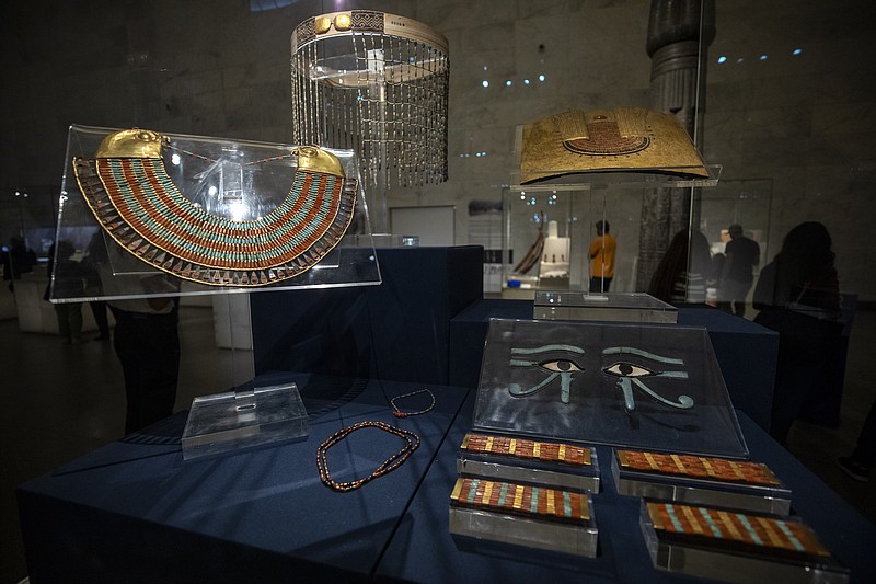 FILE - In this April 24, 2021 file photo, a collection of the jewelry of Princess Neferuptah, the daughter of King Amenemhat III, on display in its glass case at the new National Museum of Egyptian Civilization in Old Cairo.   As some European countries re-open to international tourists, Egypt has already been trying for months to attract them to its archaeological sites and museums. Officials are betting that the new ancient discoveries will set it apart on the mid- and post-pandemic tourism market(AP Photo/Nariman El-Mofty, File)