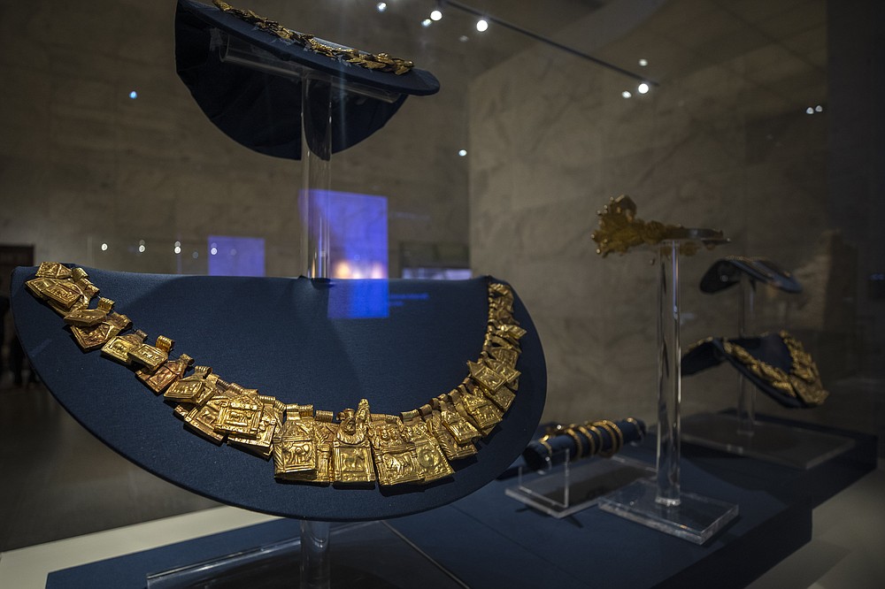 FILE - In this April 24, 2021 file photo, a fine gold collection of Douche Treasure from the Roman period, on display in its glass case at the new National Museum of Egyptian Civilization in Old Cairo. As some European countries re-open to international tourists, Egypt has already been trying for months to attract them to its archaeological sites and museums. Officials are betting that the new ancient discoveries will set it apart on the mid- and post-pandemic tourism market (AP Photo/Nariman El-Mofty, File)