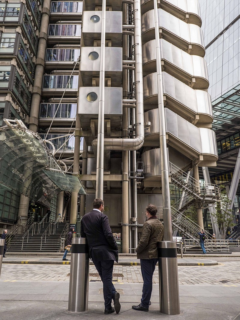 Commuters stand in view of the Lloyds of London building in the City of London on Feb. 17, 2020. MUST CREDIT: Bloomberg photo by Jason Alden.