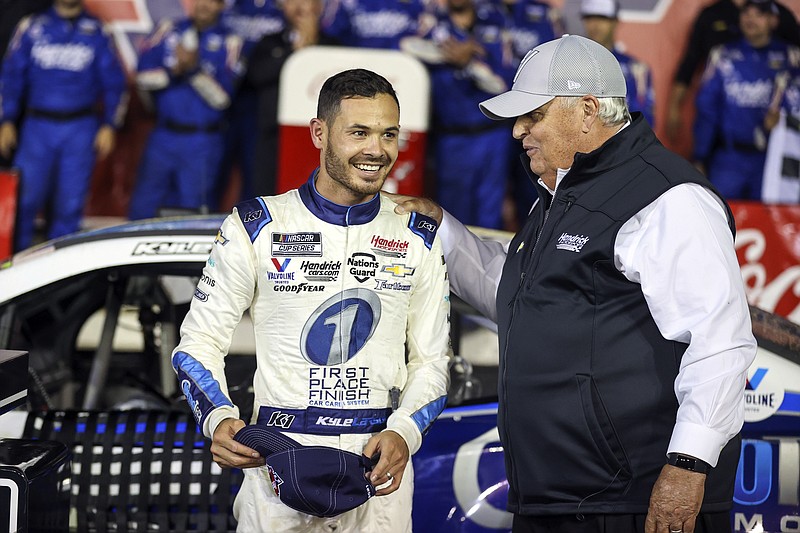 Car owner Rick Hendrick, right, congratulates Kyle Larson in victory lane after Larson won the NASCAR Cup Series auto race at Charlotte Motor Speedway in Concord, N.C., late Sunday, May 30, 2021. (AP Photo/Nell Redmond)