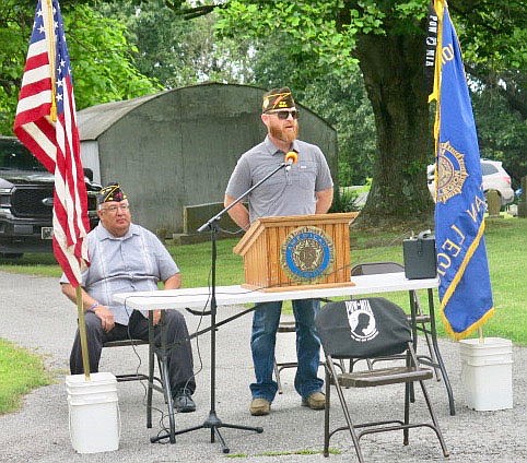 Westside Eagle Observer/SUSAN HOLLAND
Matt McClain, of Gravette, Air Force veteran and member of the Howard-Parrish VFW Post 9835, speaks to the crowd at Memorial Day services Monday, May 31, at Hillcrest Cemetery. McClain was crew chief of the USAF Viper West aerobatic flight demonstration team and responsible for maintenance on the F-16s flown in their shows.