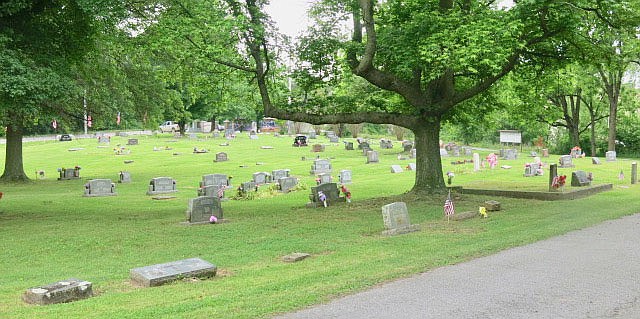 Westside Eagle Observer/SUSAN HOLLAND
Flags mark the graves of each veteran buried at Hillcrest Cemetery and flowers decorate the burial places of many of the fallen as one gazes across the hillside on Monday, May 31, just after the annual Memorial Day service. The flags are placed on veterans' graves by members of the John E. Tracy American Legion Post 25 in Gravette.