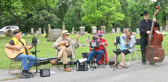 Westside Eagle Observer/SUSAN HOLLAND
Members of the Old Town String Band play "The Star-Spangled Banner," the country's national anthem, just before the flag-raising at Gravette's Memorial Day service. The band also played "America the Beautiful" near the end of the service. Pictured are Al Blair, Jeff Davis, Mary Bourn, Linda Damron and Randy Cannon.