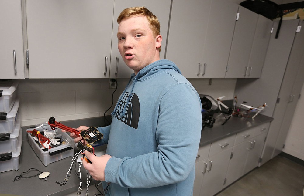 Kyle King, a ninth grade student at Elkins High School, displays Monday, May 17, 2021, a wiring harness, in the former computer lab classroom at the high school. Elkins High School and Elkins Middle School will be partnering with Amazon in the years ahead to enhance the district's computer science program. The high school will be renovating a classroom this summer in order to create a state-of-the-art maker space for computer science and robotics for students next year. Check out nwadg.com/photos for a photo gallery.
(NWA Democrat-Gazette/David Gottschalk)