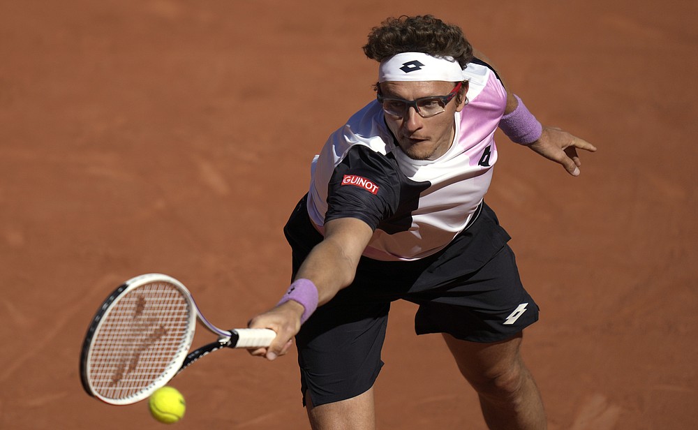 Uzbekistan's Denis Istomin plays a return to Switzerland's Roger Federer during their first round match on day two of the French Open tennis tournament at Roland Garros in Paris, France, Monday, May 31, 2021. (AP Photo/Thibault Camus)