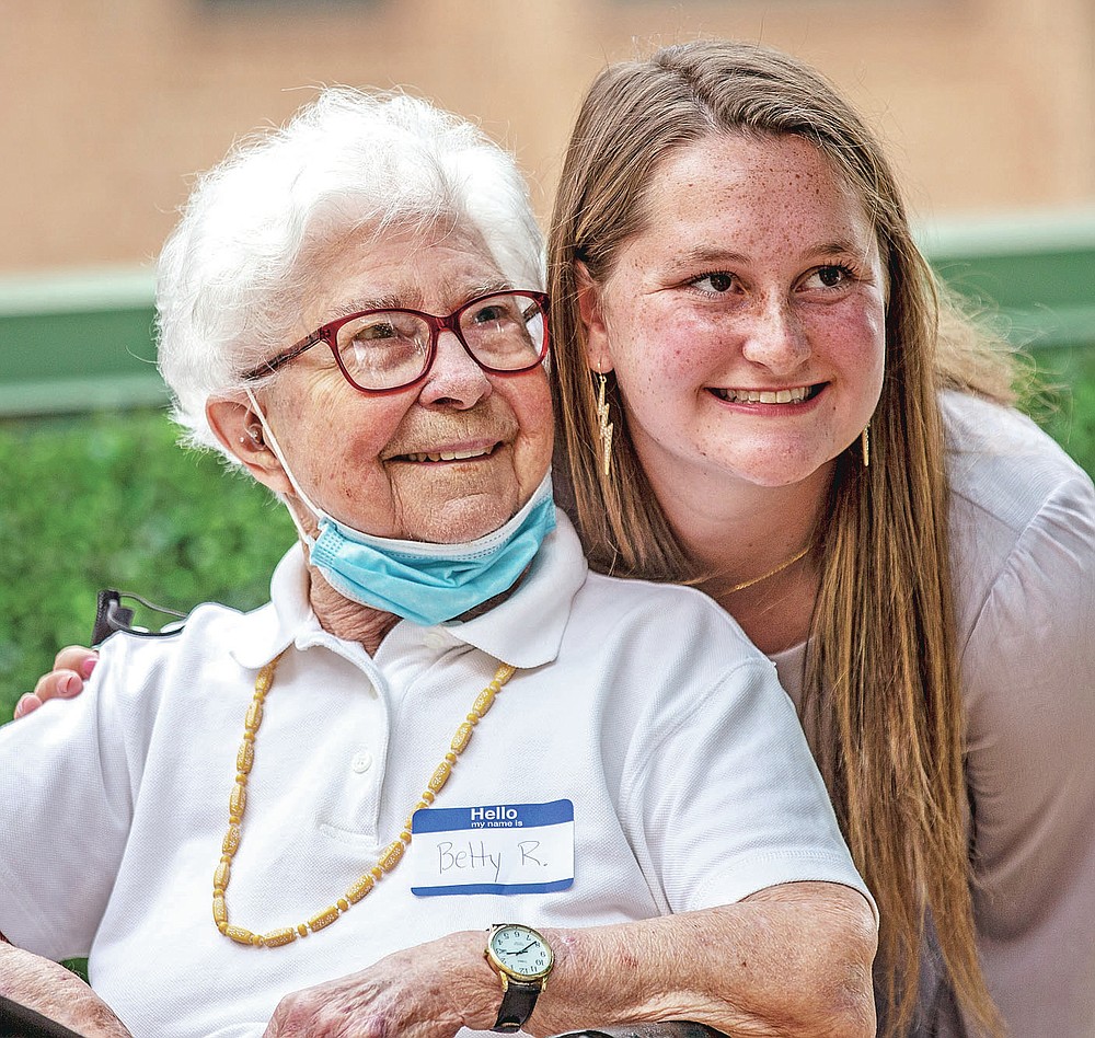 Betty Ries and Sidney Smith pose for a photo at the Grimsley Pen Pal Club reception at Heritage Greens Senior Living in Greensboro, N.C., on Sunday, May 16, 2021. Smith founded the Penpal Club. (Woody Marshall/News & Record via AP)