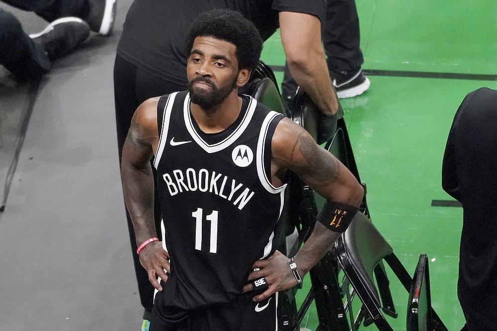 Brooklyn Nets guard Kyrie Irving looks up at the fans at TD Garden after they defeated the Boston Celtics in Game 4 during an NBA basketball first-round playoff series, Sunday, May 30, 2021, in Boston. Irving was booed and heckled by the fans all game. (AP Photo/Elise Amendola)