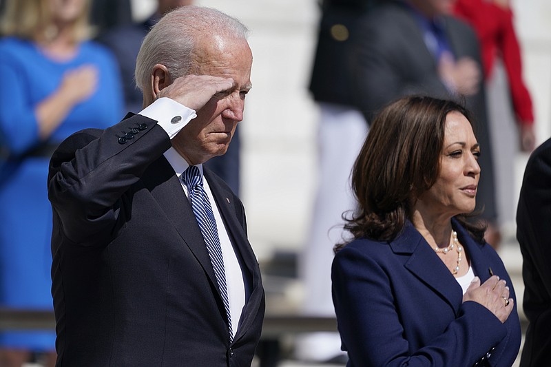 President Joe Biden and Vice President Kamala Harris stand at attention after placing a wreath at the Tomb of the Unknown Soldier at Arlington National Cemetery on Memorial Day, Monday, May 31, 2021, in Arlington, Va.(AP Photo/Alex Brandon)