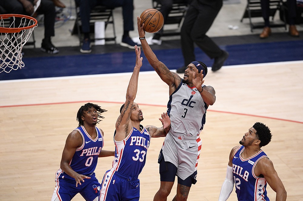 Washington Wizards guard Bradley Beal (3) goes to the basket against Philadelphia 76ers guard George Hill (33), forward Tobias Harris (12) and guard Tyrese Maxey (0) during the first half of Game 4 in a first-round NBA basketball playoff series, Monday, May 31, 2021, in Washington. (AP Photo/Nick Wass)