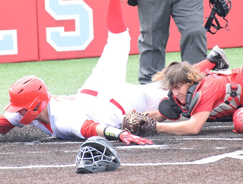 RICK PECK/SPECIAL TO MCDONALD COUNTY PRESS McDonald County catcher Jake Gordon tags out a runner from Webb City in the top of the seventh inning after receiving a throw from right fielder Colton Ruddick to cut down the go-ahead run in McDonald County's 6-5 win on May 30 in a tournament at Joplin.