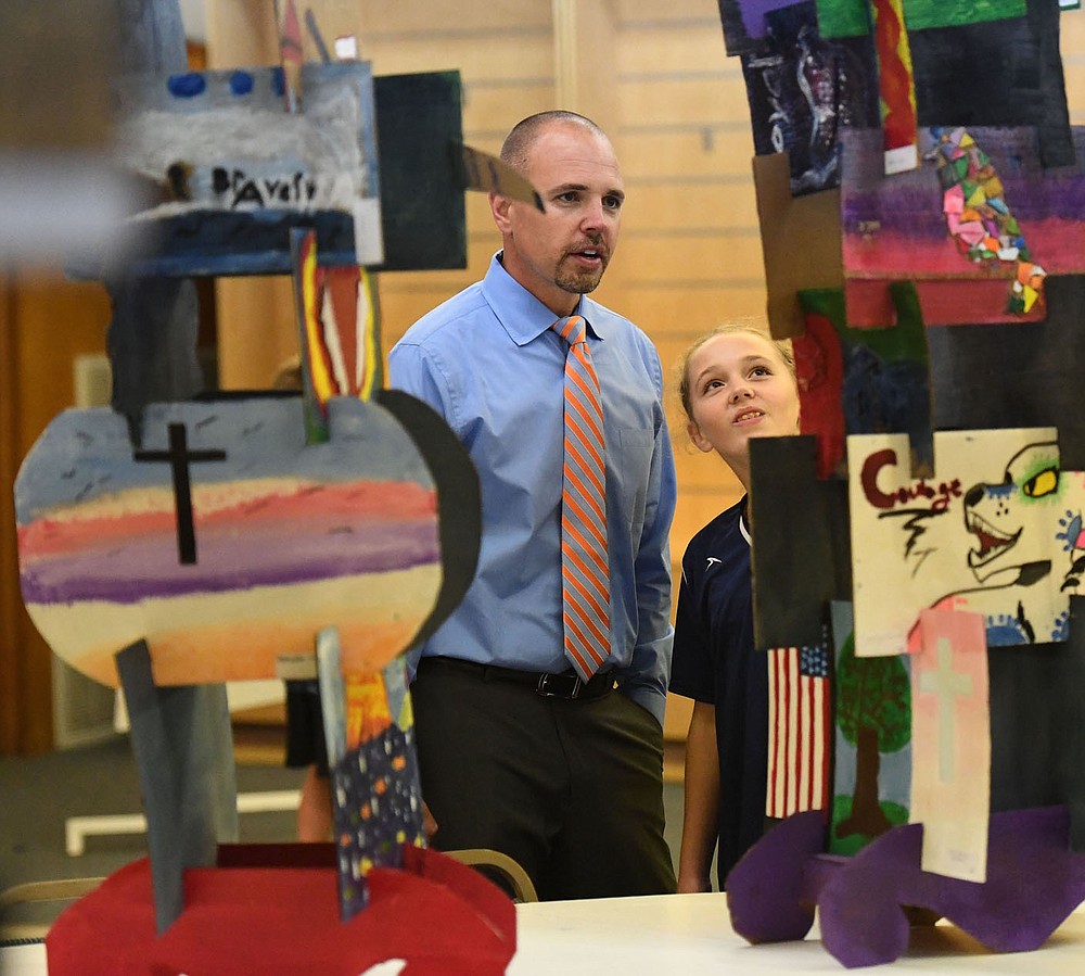 NWA Democrat-Gazette/J.T. WAMPLER Jeremy Yates of Bentonville looks at art Thursday Oct. 10, 2019 with his daughter Adalynn Yates ((CQ)), 11, at the Rogers Experimental House during Art on the Bricks in downtown Rogers. Downtown shops welcome visual and musical artists from Northwest Arkansas on the second Thursday of every month with pop-up galleries, art demos, live music and artist receptions.
For more information visit www.godowntownrogers.com/art-on-the-bricks