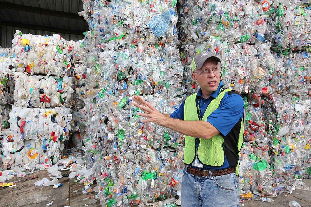 Brian Pugh, waste reduction coordinator with the city of Fayetteville, describes Friday, June 11, 2021, the demand for both number 1 and 2 plastic bottles at the Material Recovery Facility for the Recycling and Trash Collection Division for the city. The Northwest Arkansas Council is proposing a circular economy that makes use of regional recycling programs to create new businesses and jobs and reduce waste. Check out nwadg.com/photos for a photo gallery.
(NWA Democrat-Gazette/David Gottschalk)